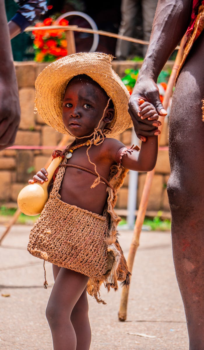 a-young-african-child-in-a-straw-hat-and-dress-27433124